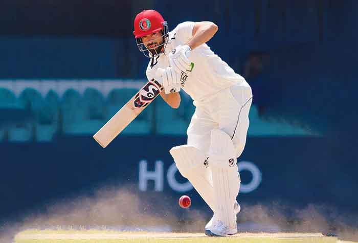 A remarkable maiden Test hundred by Ibrahim Zadran helped Afghanistan to recover in the one-off Test against Sri Lanka at Sinhalese Sports Club ground in Colombo as the tourists ended day three on 199 for one on Sunday. Having conceded a first innings lead of 241, Afghanistan had to show fight in the second essay after being shot out for 198 in the first innings. Ibrahim went past his previous best Test score of 87 and then went onto complete his maiden Test hundred in the last over of the day with a single to covers and was unbeaten on 101. It is only the fourth Test hundred by an Afghan. The 22-year-old opening batsman was given two reprieves; first on 39 when Prabath Jayasuriya put down a tough return catch and then on 63 Nishan Madushka at short mid-off dropped a catch again off the bowling of Jayasuriya. The wicket had flattened out but still the Afghan batters had to show application and they put up a remarkable show as Sri Lanka struggled to find the breakthroughs. It was a disciplined effort by the bowlers though not giving away too many loose deliveries. Jayasuriya was required to bowl long spells and he ended up sending down 32 overs but wasn’t able to pick up a wicket. A record 106 run stand for the first wicket between Ibrahim and Noor Ali set the platform for Afghanistan’s second innings.It is a new record for Afghanistan improving on the 53 run stand between Ibrahim himself and Javed Ahmadi against West Indies in Lucknow in 2019. After tea, Asitha Fernando tested the batters reverse swinging the ball and dismissed Noor Ali for 47 when he trapped the debutant leg before wicket. It was a much-needed breakthrough for Sri Lanka having failed to pick up a wicket in the entire afternoon session. Rahmat Shah, the top scorer in the first innings, then joined Ibrahim and added an unbroken 93 runs for the second wicket. He was 46 not out.fea The Concussion Substitute Rule came into effect as seam bowler Chamika Gunasekara had to be pulled out after being struck on the helmet by a nasty Naveed Zadran delivery. A concussion test was conducted soon after the tail-ender had got hit. He continued to bat on but three overs later complained to the umpire about discomfort and after examination by the physiotherapist had to leave the field. Sri Lanka appealed to Match Referee Chriss Broad for the player to substituted and it was allowed with seam bowler Kasun Rajitha replacing Gunasekara, who was playing his maiden Test.Earlier, Sri Lanka resuming from the overnight total of 410 for six and were bowled out for 439 as they lost their last four wickets for 12 runs.